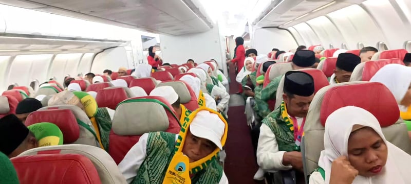 Pilgrims seated on the airplane heading to Jeddah